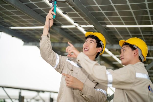 Ingeniero de planta de energía solar examinando solución eléctrica de mantenimiento de técnico de paneles fotovoltaicos