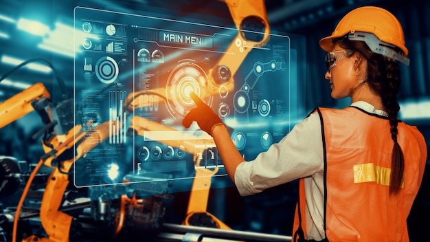 Ingeniero utiliza brazo robot de industria de control de software robótico cibernético en fábrica
