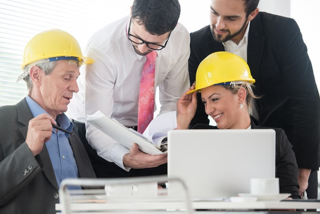 Ingenieurbüro mit den älteren und jungen Architekten, die an neuem Projekt arbeiten