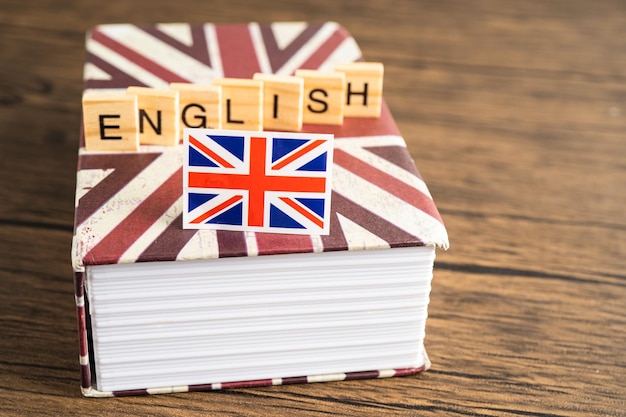 Inglês da palavra no livro com a bandeira do Reino Unido aprendendo o conceito de cursos de língua inglesa