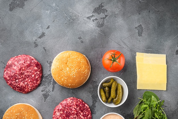 Foto ingredientes para cocinar hamburguesas. conjunto de chuletas de carne de res molida cruda, en piedra gris