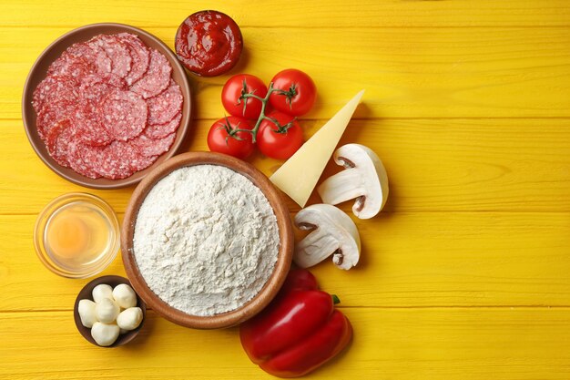 Foto ingredientes para pizza em fundo de madeira