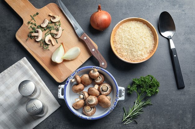 Foto ingredientes para risoto com cogumelos na mesa cinza