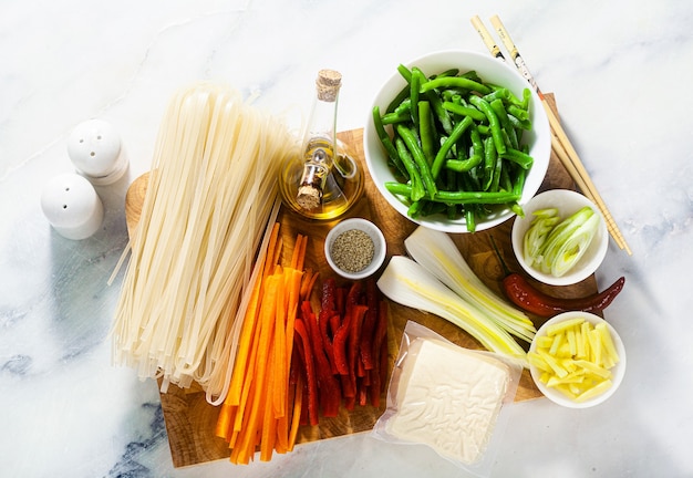 Ingredientes tailandeses em uma tábua de cortar sobre uma mesa de mármore branco