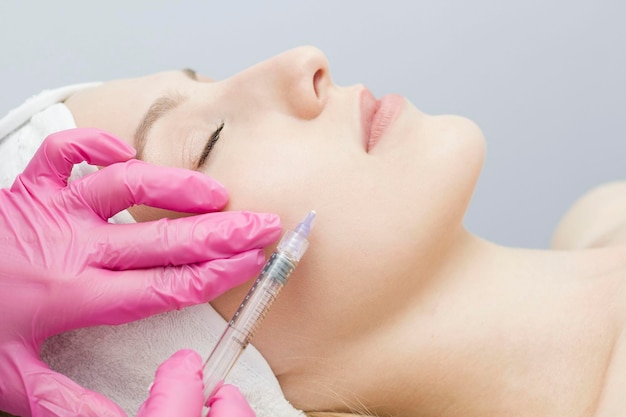 Injeção no rosto no salão spa As mãos do médico Biorevitalização Cuidados faciais com ácido hialurônico