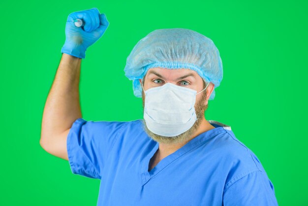Injektionsarzt in medizinischer Maske und Handschuhen hält Spritze mit Impfstofffacharzt mit