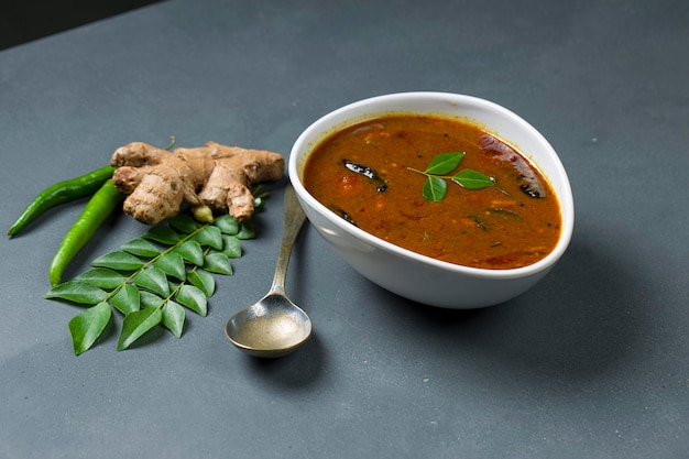 Inji Puli oder Puli InjiKerala traditionelle Festbeilage aus Tamarinden-Ingwer und grünem Chili, die in einem weißen Geschirr mit grauem Hintergrund angeordnet sind