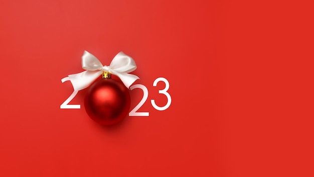 Una inscripción inusual 2023 con una bola de Navidad Un símbolo del próximo feliz año nuevo