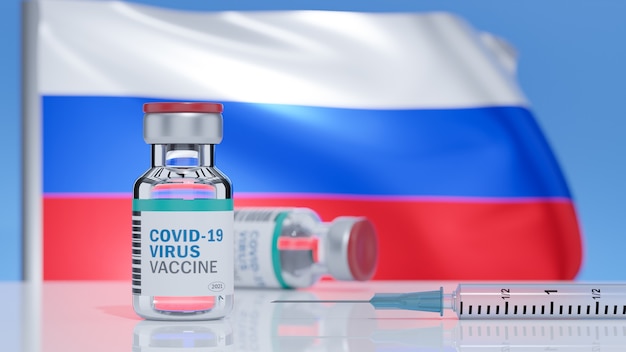 Se inserta una jeringa con una aguja en el vial, etiquetado con la palabra vacuna Covid-19 en una bandera de la superficie de Rusia