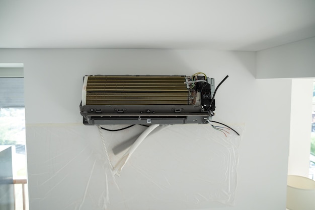 Instalación del sistema de aire acondicionado en la habitación con pared blanca en el primer plano de la oficina del apartamento