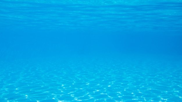 Foto instantâneo sob a água de uma bela piscina azul em um dia ensolarado