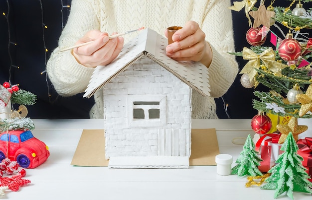 Foto instrucciones fotográficas paso a paso para hacer una decoración navideña una casa de cartón paso 1 preparando un pincel y pintura