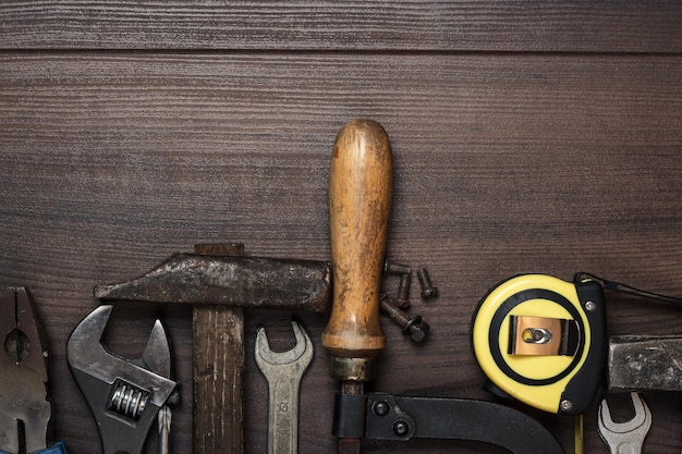 Instrumentos de construcción en el fondo de madera marrón.