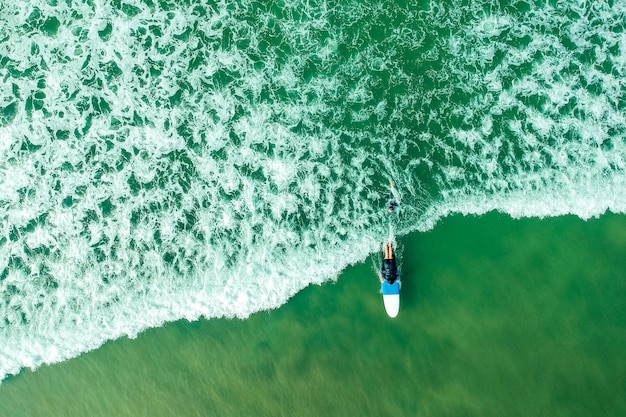 Instrutor de surf e mulher aprendendo esportes aquáticos radicais em Goa