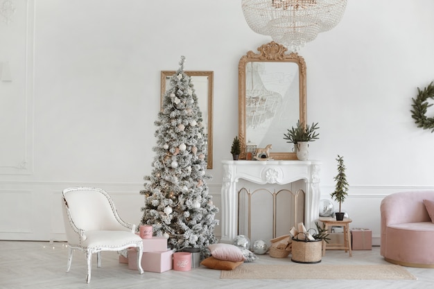 Interior acogedor salón con chimenea vintage y árbol de navidad decorado con regalos debajo ...