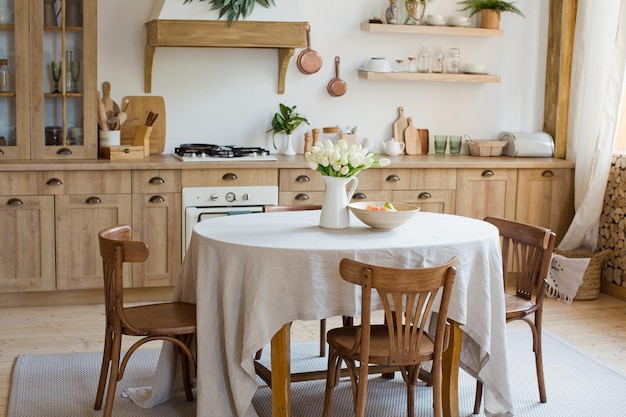 Interior de cocina de madera clara con mesa en el medio del comedor Hermoso diseño de interiores de cocina