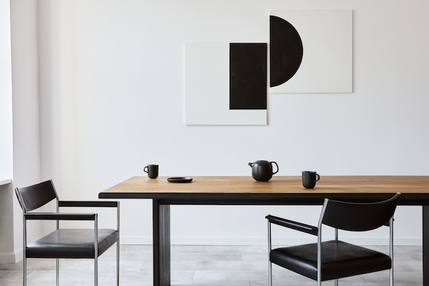 Interior de comedor elegante con mesa familiar de madera de diseño, sillas negras, tetera con taza