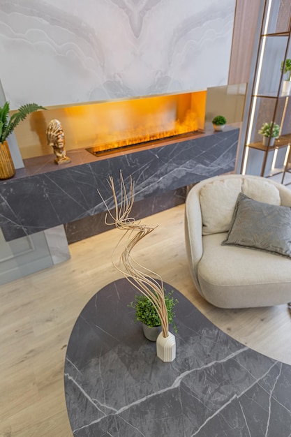 Interior de luxo elegante do estúdio moderno em tons pastéis verdes com elementos de madeira móveis caros e decorações aconchegante área de estar ao lado da lareira