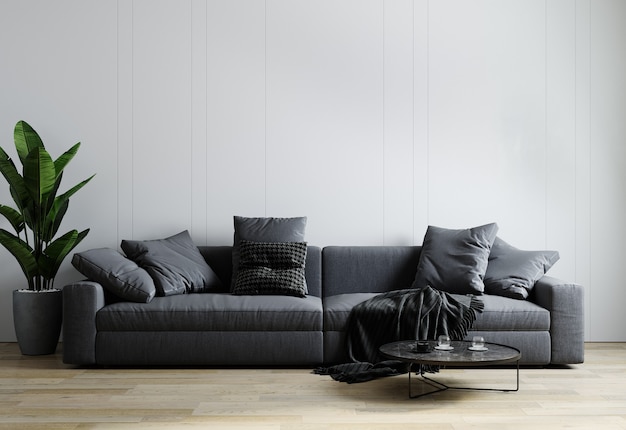 Interior elegante de sala de estar bem iluminada com sofá cinza, planta e mesa de centro com decoração.