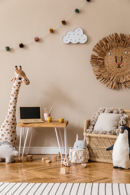 Interior escandinavo elegante de quarto infantil com brinquedos naturais, decoração suspensa, móveis de design, animais de pelúcia, ursinhos de pelúcia e acessórios. Paredes bege. Design de interiores da sala de criança. Modelo.