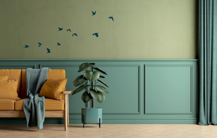 Interior de habitación verde con planta de caucho de sofá amarillo y gráfico de pájaros voladores en la pared