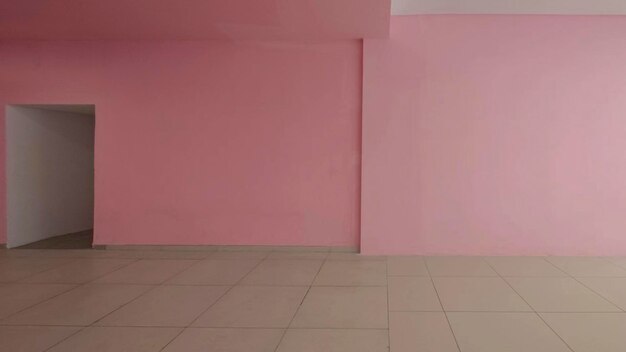 En el interior hay una pared y un piso rosados vacíos.