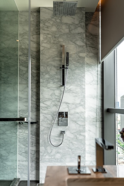 Foto interior moderno de banheiro com conjunto de chuveiro de aço inoxidável e parede de mármore branco natural / design de interiores / espaço de cópia