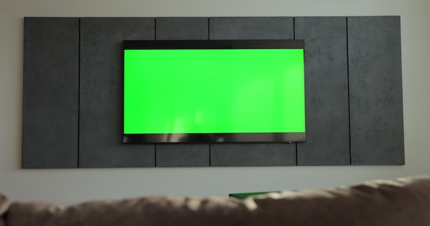 Foto interior moderno de la sala de estar con televisión inteligente con pantalla verde maqueta de cine concepto de televisión con llave de croma