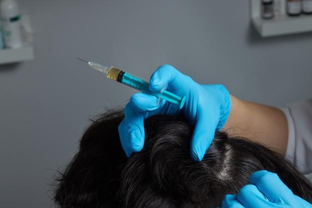 Inyección de plasma en el cabello de la cabeza hombre cosmetólogo médico