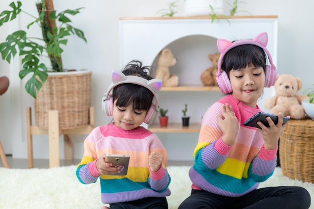 Irmãos meninas ouvindo música com fone de ouvido felizes juntos