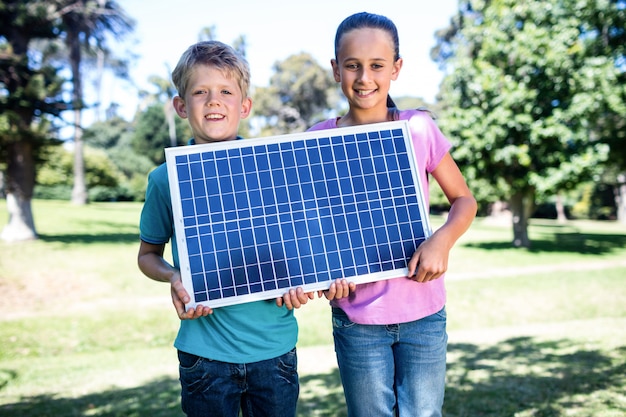 Irmãos segurando um painel solar
