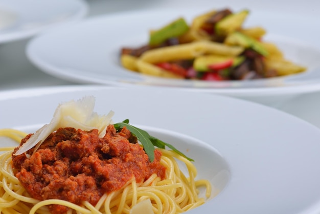 Italienische Spaghetti mit Bolognese oder Bolognese, Sauce mit Tomaten, Fleisch und Käse auf einem schlichten weißen Teller