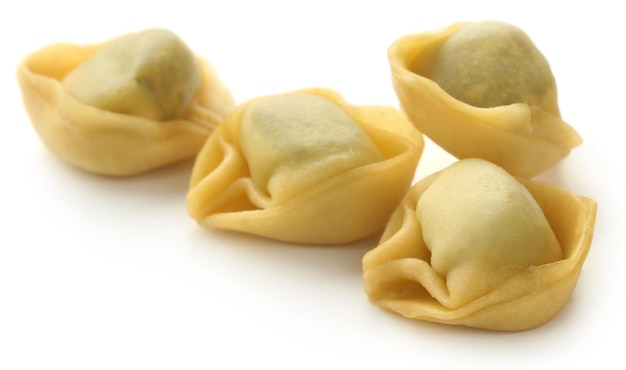 Italienische Tortelloni aus Spinat und Weizenmehl auf weißem Hintergrund