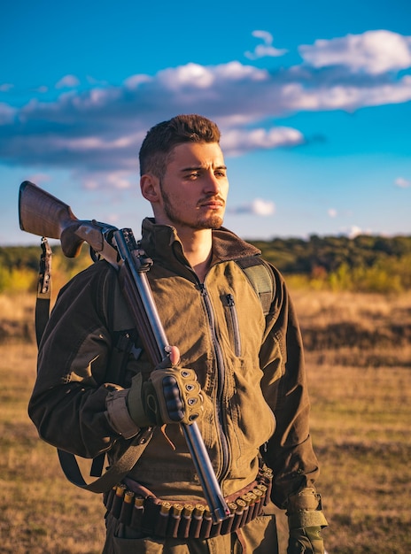 Jäger mit Schrotflinte auf der Jagd Patronenschrotflinte Aufspüren Close up Portrait von hamdsome Hunter