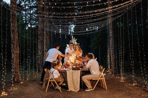 Jantar de casamento em família à noite na floresta