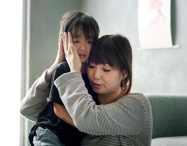 Japanische Mutter, die ihre Tochter tröstet