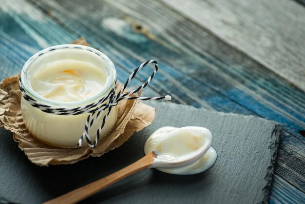 Jar com iogurte fresco em uma mesa rústica