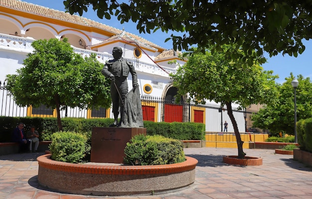 El jardín con estatua y monumento al torero Curro Romero ubicado cerca de la plaza de toros en la plaza de toros en el centro histórico de Sevilla España