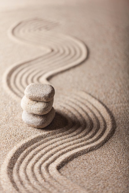 Foto jardín zen con arena rastrillada y guijarros en equilibrio