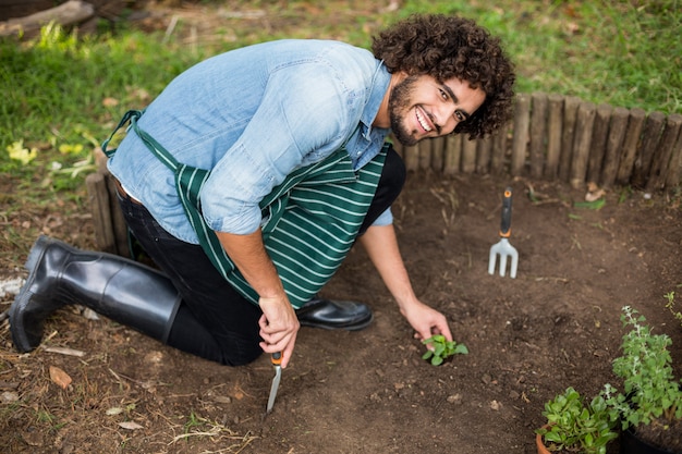 Jardinero plantando fuera del invernadero