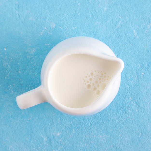 Foto jarra de leche en un azul