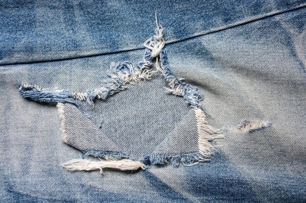 Foto jeans de denim azul rasgados destruidos con textura de costura y fondo
