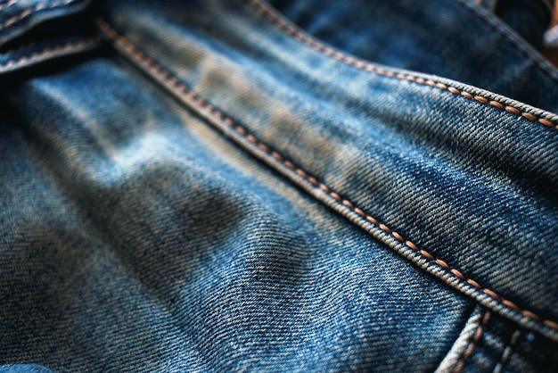 Jeans de mezclilla azul con costuras amarillas Primer plano de una tela de moda