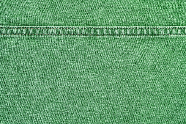 Jeans de mezclilla verde con un fondo de textura de costura