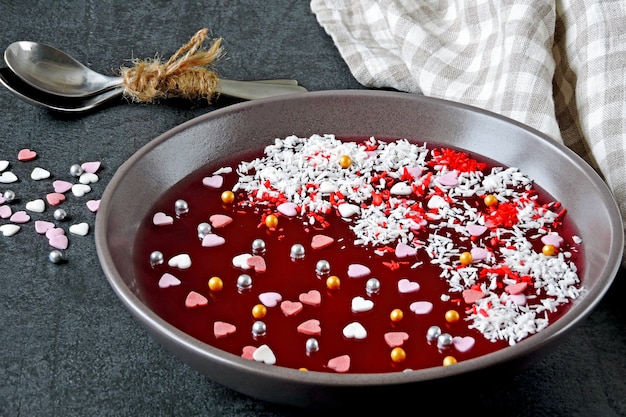 Jelly Bowl zum Valentinstag. Schöne Platte mit Marmelade und Valentinstagdekorationen. Dessert zum Valentinstag.