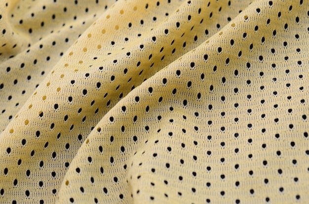 Jersey de deporte amarillo ropa textura de tela y fondo con muchos pliegues
