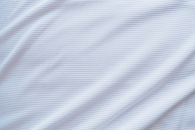 Jersey de fútbol blanco ropa tela textura deportes desgaste fondo, primer plano