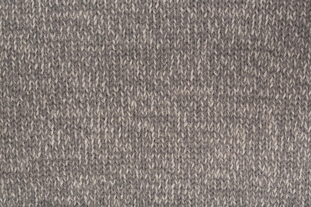 Jersey de invierno de lana gris oscuro. De cerca. Fondo