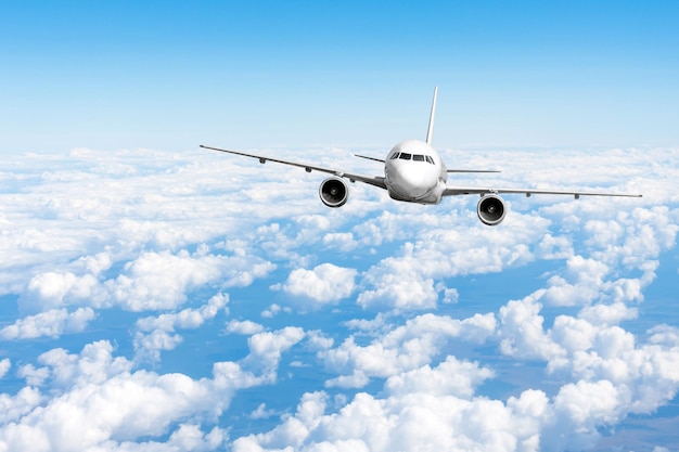 Jet de avión volando a nivel de vuelo alto en el cielo por encima de las nubes y el cielo azul