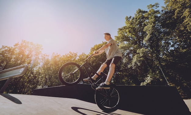 Jinete de BMX realizando trucos en skatepark.